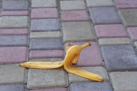Banana peel was left on the pavement. The danger may slip. If anyone walks on it. Be careful of slippery. Close up, outdoorsの写真素材
