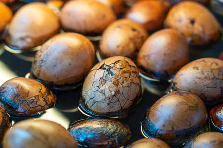 Chinese tea herbal eggs beneficial for general health at retail outlet. Boiled soy eggs for sell in...
