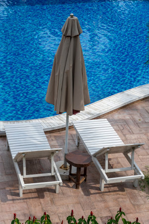 Summer outdoor swimming pool and sun loungers near sea on the tropical beach in Phu Quoc island, Vietnam, Southeast Asia. Concept of holiday and the travelのeditorial素材