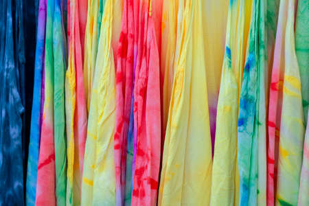 Colorful summer clothes on hangers for sale in local street market in Thailand, close upの写真素材