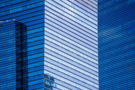 High glass skyscrapers on the streets of Singapore. Office windows background, close up