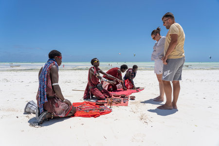 Zanzibar, Tanzania - november 11, 2019: Masai African men sell souvenirs for tourists on the beach near the ocean on the sand beach, island Zanzibar, Tanzania, East Africaのeditorial素材