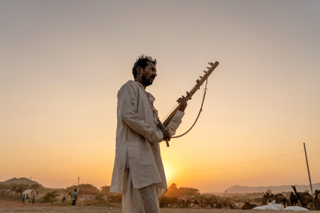PUSHKAR, INDIA - NOVEMBER 12, 2018: Unidentified indian musician at the attended the annual Pushkar Camel Mela near holy city Pushkar, Rajasthan, Indiaのeditorial素材