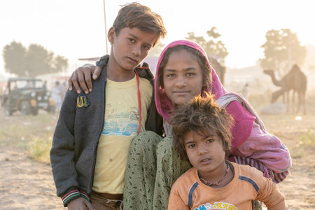 PUSHKAR, INDIA - NOVEMBER 12, 2018: Indian children in the desert Thar on time Pushkar Camel Mela near holy city Pushkar, Rajasthan, Indiaのeditorial素材