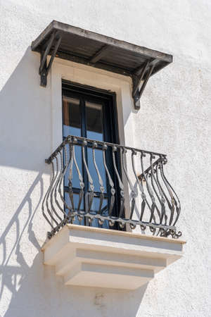 Windows with balcony on building facade with cast iron ornaments in Bodrum, Turkeyの写真素材