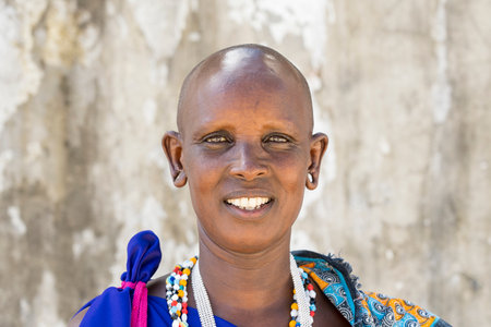 Zanzibar, Tanzania - october 29, 2019: African woman masai dressed in traditional clothes standing on the street of Zanzibar island, Tanzania, East Africaのeditorial素材