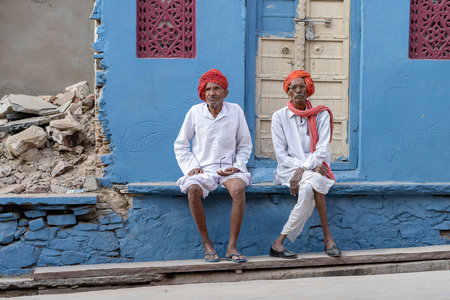 PUSHKAR, INDIA - NOVEMBER 16, 2018: Two old bedouin man sitting on the street on time Pushkar Camel Mela in the holy city Pushkar, Rajasthan, Indiaのeditorial素材