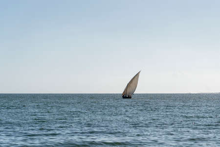 Traditional fishing sailing boat during sunset on Indian ocean in island Zanzibar, Tanzania, East...