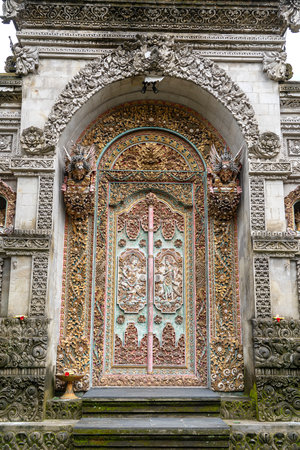 Traditional temple door in Ubud, Island Bali, Indonesia. Close up. Entrance to indonesia hindu temple with carved wooden doorの写真素材