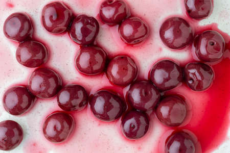 Cherries in alcohol in their own juice in a plate, close up, top view. Fresh ripe red cherry soaked in alcohol on plateの写真素材