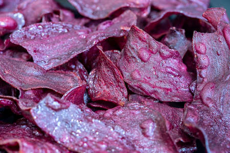 Fried purple sweet potato chips as snacks, close up, thai foodの写真素材
