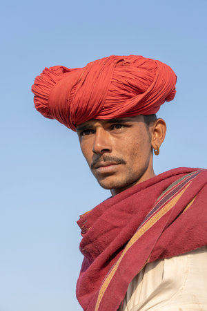 PUSHKAR, INDIA - NOVEMBER 14, 2018: Indian man in the desert Thar during Pushkar Camel Mela near holy city Pushkar, Rajasthan, India. This fair is the largest camel trading fair in the world.のeditorial素材