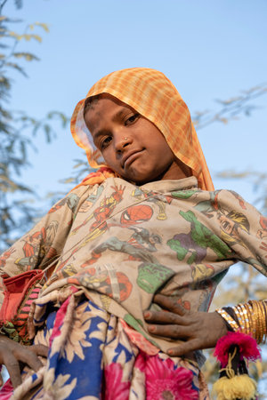 PUSHKAR, INDIA - NOVEMBER 17, 2018: Indian young girl in the desert Thar on time Pushkar Camel Mela near holy city Pushkar, Rajasthan, India, close up portraitのeditorial素材