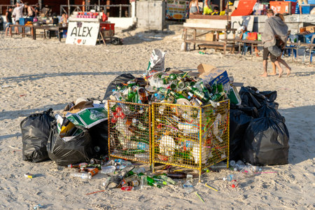 KOH PHANGAN, THAILAND - FEBRUARY 21, 2019: Rubbish on a sandy beach near the sea after a Full Moon party in island Koh Phangan, Thailandのeditorial素材