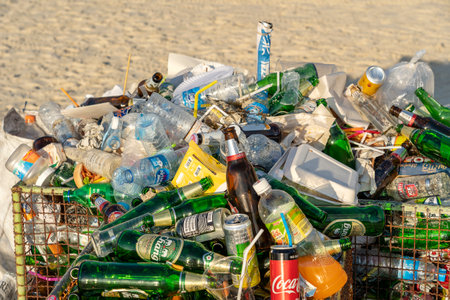 KOH PHANGAN, THAILAND - FEBRUARY 21, 2019: Rubbish on a sandy beach near the sea after a Full Moon party in island Koh Phangan, Thailandのeditorial素材