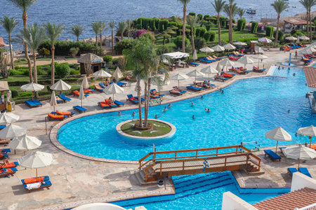 SHARM EL-SHEIKH, EGYPT - MAY 20, 2018: swimming pool early in the morning next to the red sea in the resort hotel in Sharm El Sheikh, South Sinai, Egyptのeditorial素材