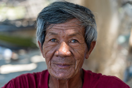 Cu Lao Cham, Vietnam - June 11, 2020: Ethnic old man on a street market of Cu Lao Cham island near Danang, Vietnamのeditorial素材