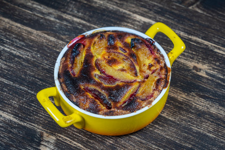 Homemade organic plum pie dessert ready to eat. Plum tart on the old wooden background, close upの写真素材
