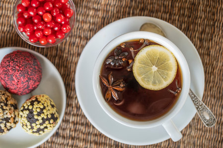 Spice tea, consisting of cinnamon, black pepper, cardamom, star anise, lemon, cloves and hot apple juice. Close up, top view. Cinnamon tea. Tea drinkの写真素材