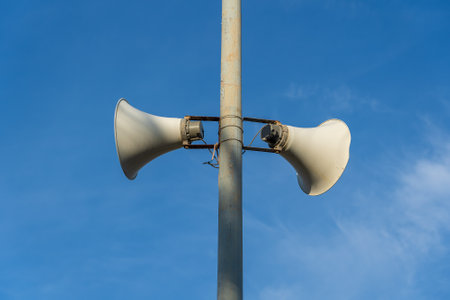Loudspeaker on the concrete pillar against the background of blue sky, Vietnamの写真素材