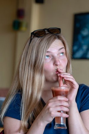 Girl drinks watermelon fresh juice, close up, healthy lifestyle conceptの写真素材