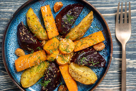 Oven baked vegetable fries with carrots, potato and beets in plate, top view, close upの写真素材