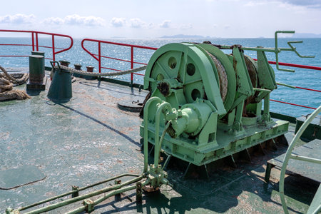A thick rope is wrapped around a drum on deck of a ferry boat, Thailand. Close up