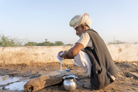 PUSHKAR, INDIA - NOVEMBER 13, 2018: Indian man in the desert Thar during Pushkar Camel Mela near...