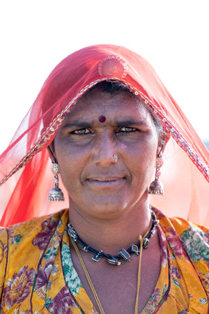 PUSHKAR, INDIA - NOVEMBER 13, 2018: Indian woman in the desert Thar during Pushkar Camel Mela near...