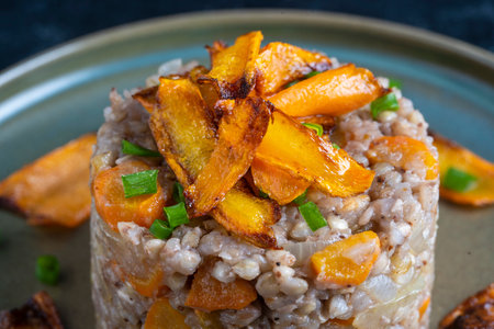 Boiled buckwheat with fried carrots and onions, close up. Food background. Healthy foodの写真素材