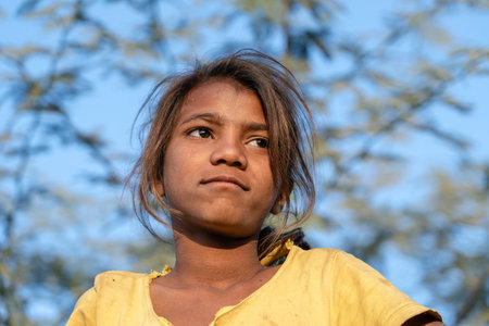 PUSHKAR, INDIA - NOVEMBER 17, 2018: Indian young girl in the desert Thar on time Pushkar Camel Mela near holy city Pushkar, Rajasthan, India, close up portraitのeditorial素材