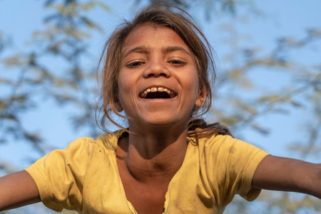 PUSHKAR, INDIA - NOVEMBER 17, 2018: Indian young girl in the desert Thar on time Pushkar Camel Mela near holy city Pushkar, Rajasthan, India, close up portraitのeditorial素材