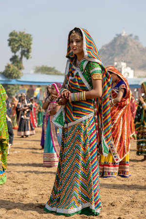 PUSHKAR, INDIA - NOVEMBER 16, 2018: Indian young girl in the desert Thar on time Pushkar Camel Mela near holy city Pushkar, Rajasthan, India, close up portraitのeditorial素材