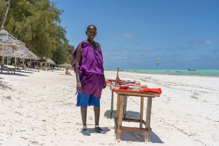 Zanzibar, Tanzania - november 11, 2019: African masai woman selling souvenirs for tourists on the beach near sea in Zanzibar island, Tanzania, east Africaのeditorial素材