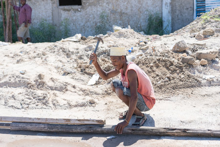Zanzibar, Tanzania - november 11, 2019: Unknown african man working on the street of Zanzibar...