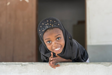 Zanzibar, Tanzania - November 11, 2019: Unidentified african girl near a local school after class in island Zanzibar, Tanzania, East Africaのeditorial素材