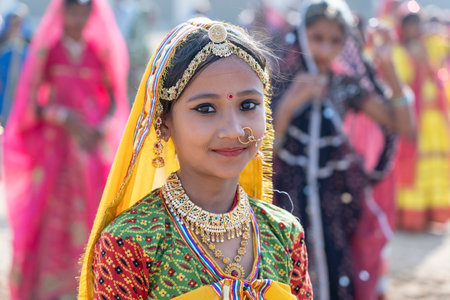 PUSHKAR, INDIA - NOVEMBER 16, 2018: Indian young girl in the desert Thar on time Pushkar Camel Mela near holy city Pushkar, Rajasthan, India, close up portraitのeditorial素材