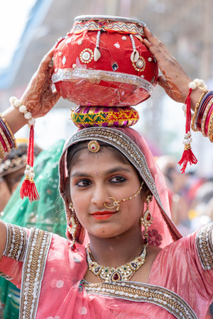 PUSHKAR, INDIA - NOVEMBER 16, 2018: Indian young girl in the desert Thar on time Pushkar Camel Mela near holy city Pushkar, Rajasthan, India, close up portraitのeditorial素材