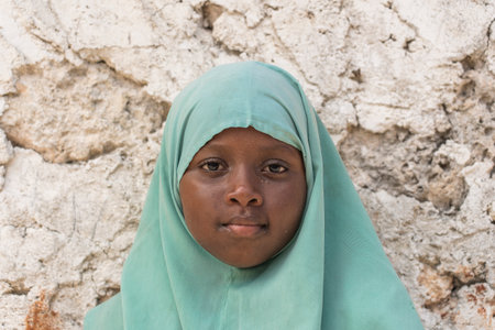 Zanzibar, Tanzania - December 09, 2019: Unidentified african girl near a local school after class in island Zanzibar, Tanzania, East Africaのeditorial素材