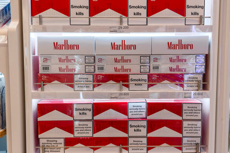 Muscat, Oman - January 19, 2020: Cigarettes department at a duty free segment store with many big packs of Marlboro on sale on a shelf in shop airportのeditorial素材