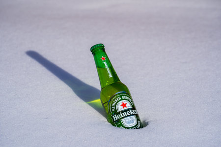 Kyiv, Ukraine - january 21, 2021: Bottle of Heineken Lager Beer on a bed of snow and white backgroundのeditorial素材