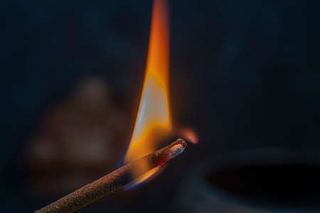Burning flame asian incense stick, close up, macro, copy spaceの写真素材
