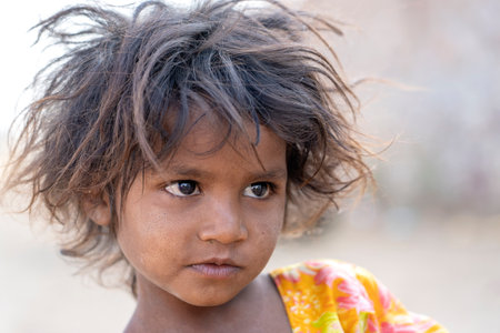 PUSHKAR, INDIA - NOVEMBER 13, 2018: Indian young girl in the desert Thar on time Pushkar Camel Mela near holy city Pushkar, Rajasthan, India, close up portraitのeditorial素材