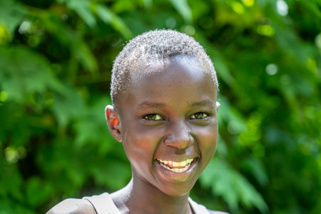 Arusha, Tanzania - December 24, 2019: Unknown african young happy boy on a street in Arusha, Tanzania, East Africa, close upのeditorial素材