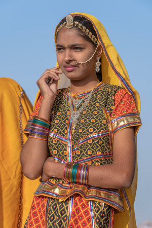 PUSHKAR, INDIA - NOVEMBER 16, 2018: Indian young girl in the desert Thar on time Pushkar Camel Mela near holy city Pushkar, Rajasthan, India, close up portraitのeditorial素材