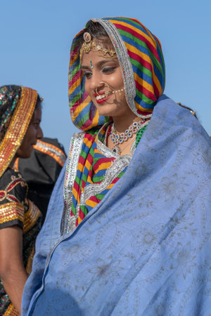 PUSHKAR, INDIA - NOVEMBER 16, 2018: Indian young girl in the desert Thar on time Pushkar Camel Mela near holy city Pushkar, Rajasthan, India, close up portraitのeditorial素材