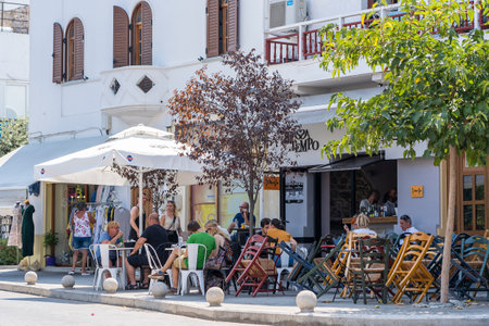 Kos island, Greece - september 04, 2019: People enjoying food and drink in a cafe in a old town in Kos island, Greece. There are many such cafes in the cityのeditorial素材