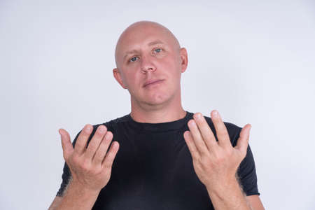 Closeup shoot of middle-aged caucasian bald man looking straight at camera. People and lifestyle concept. Portrait of middle aged man indoorsの写真素材