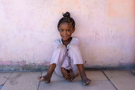 Zanzibar, Tanzania - December 12, 2019: Unknown african young girl on a street of Zanzibar island, Tanzania, East Africa, close upのeditorial素材