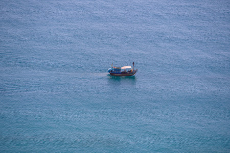 Nha Trang, Vietnam - March 30, 2020: Aerial view of a tourist boat on sea water near town of Nha Trang, Vietnamのeditorial素材